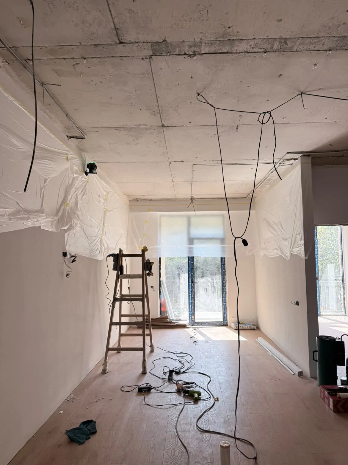 Concrete ceiling with wiring by the balcony door, before installation